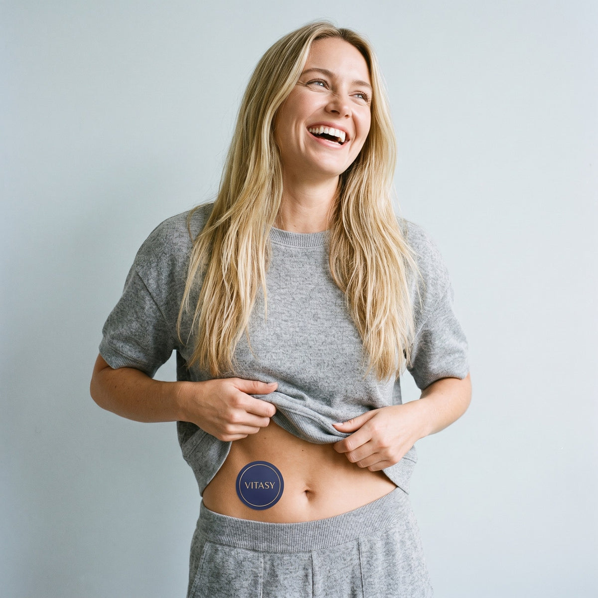 Smiling woman wearing a patch on her lower abdomen