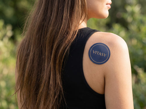 Woman wearing a Vitasy patch on her shoulder