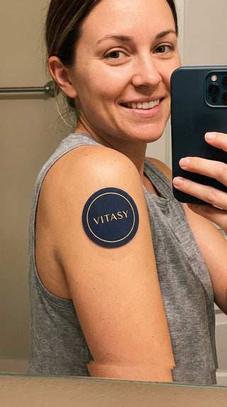 Woman showing a patch on her upper arm