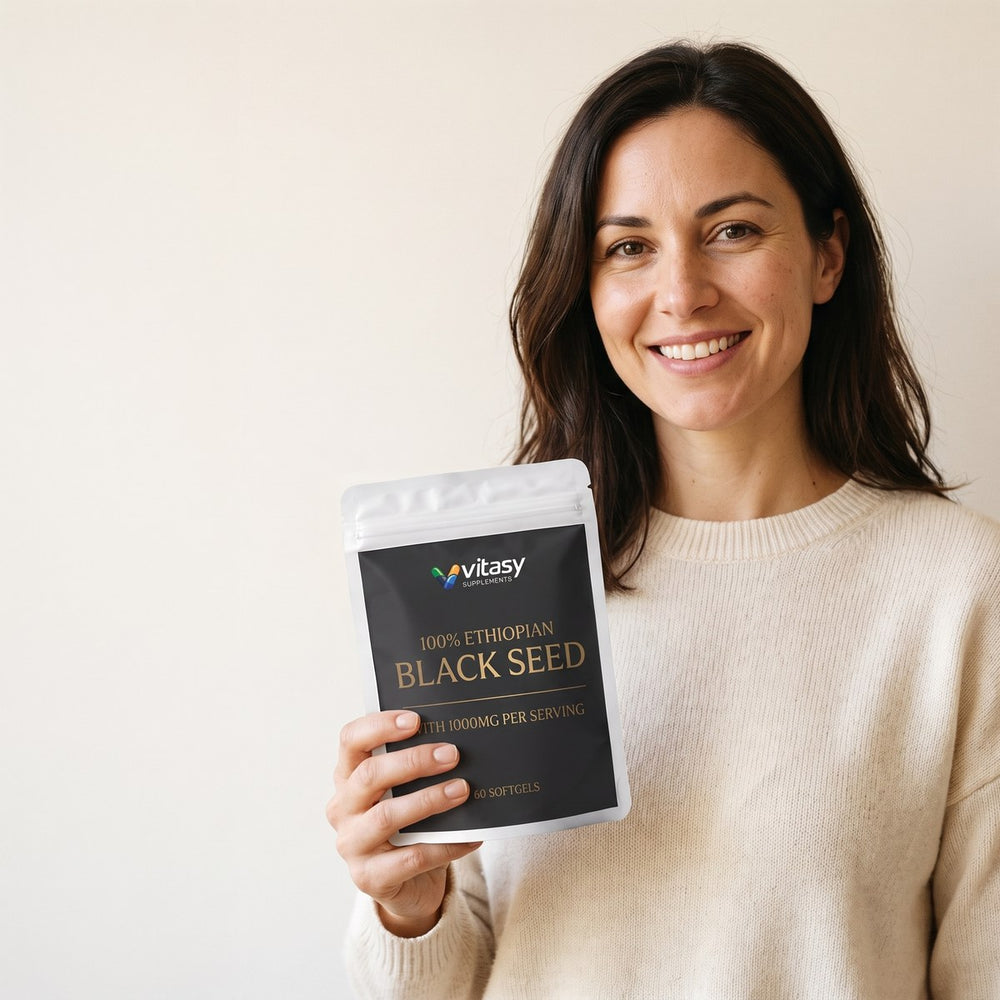 Smiling woman holding a pouch of Vitasy Ethiopian Black Seed