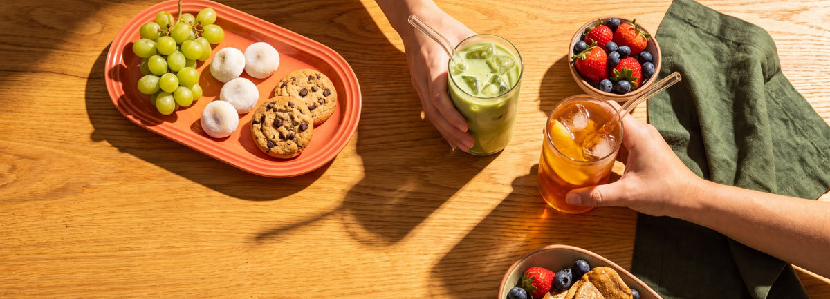 Iced matcha lattes and snacks on a sunny brunch table