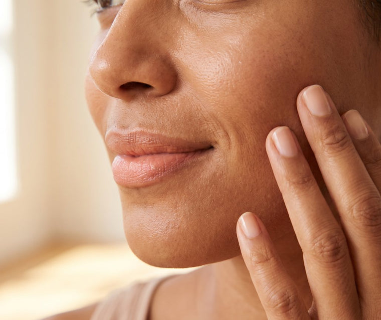 Close-up of a woman touching her cheek