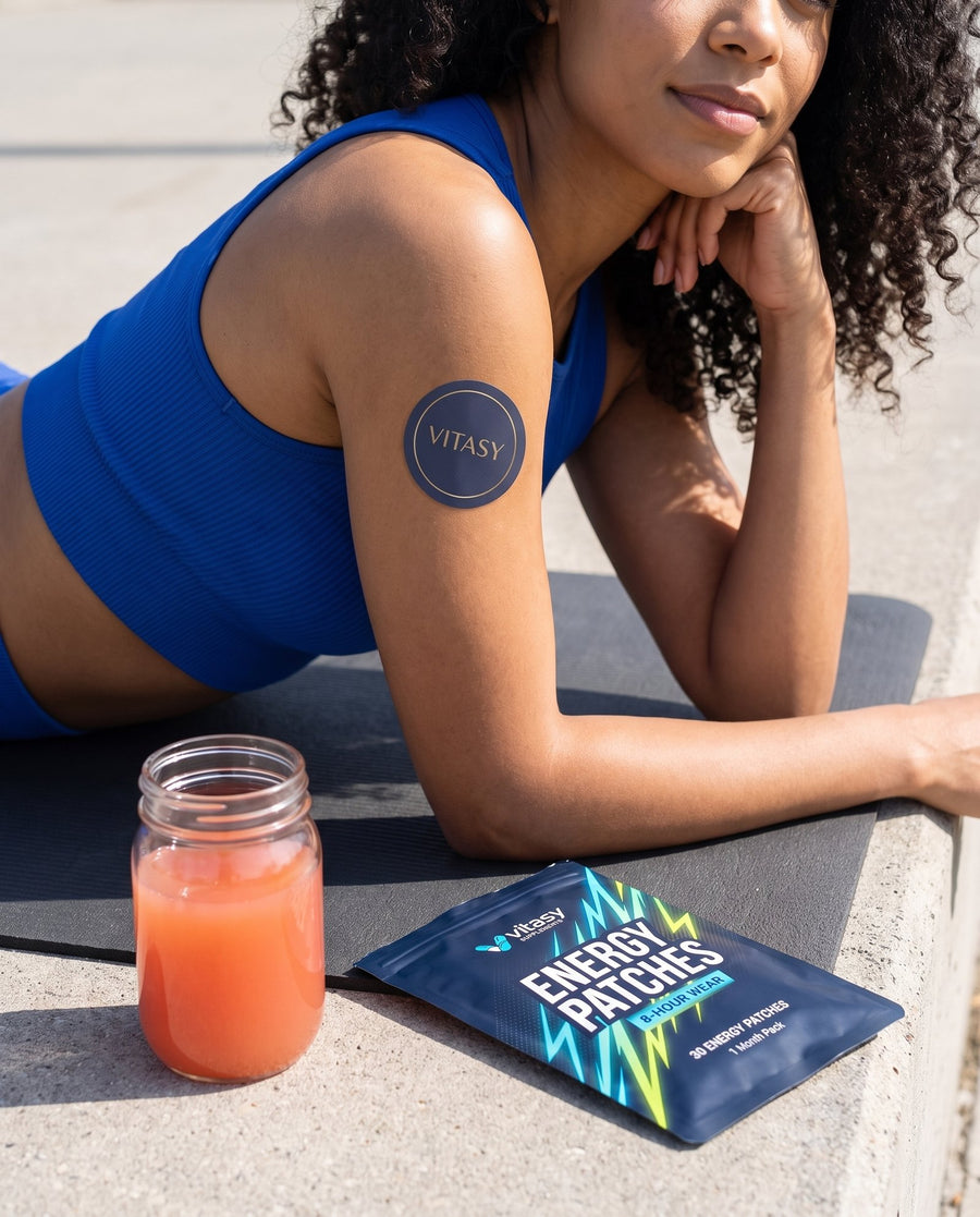 Woman on a yoga mat wearing a Vitasy energy patch
