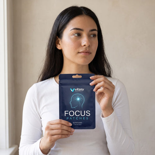 Woman in a white top holding a Vitasy pouch