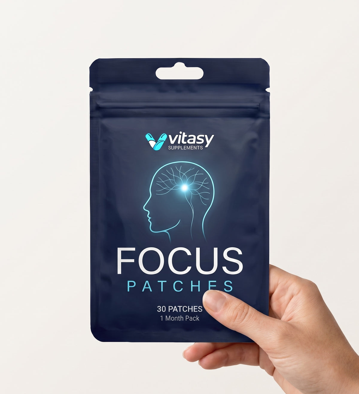Hand holding a pouch of Vitasy Focus Patches
