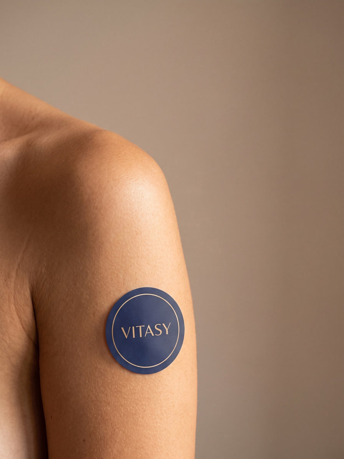 Vitasy patch on a shoulder