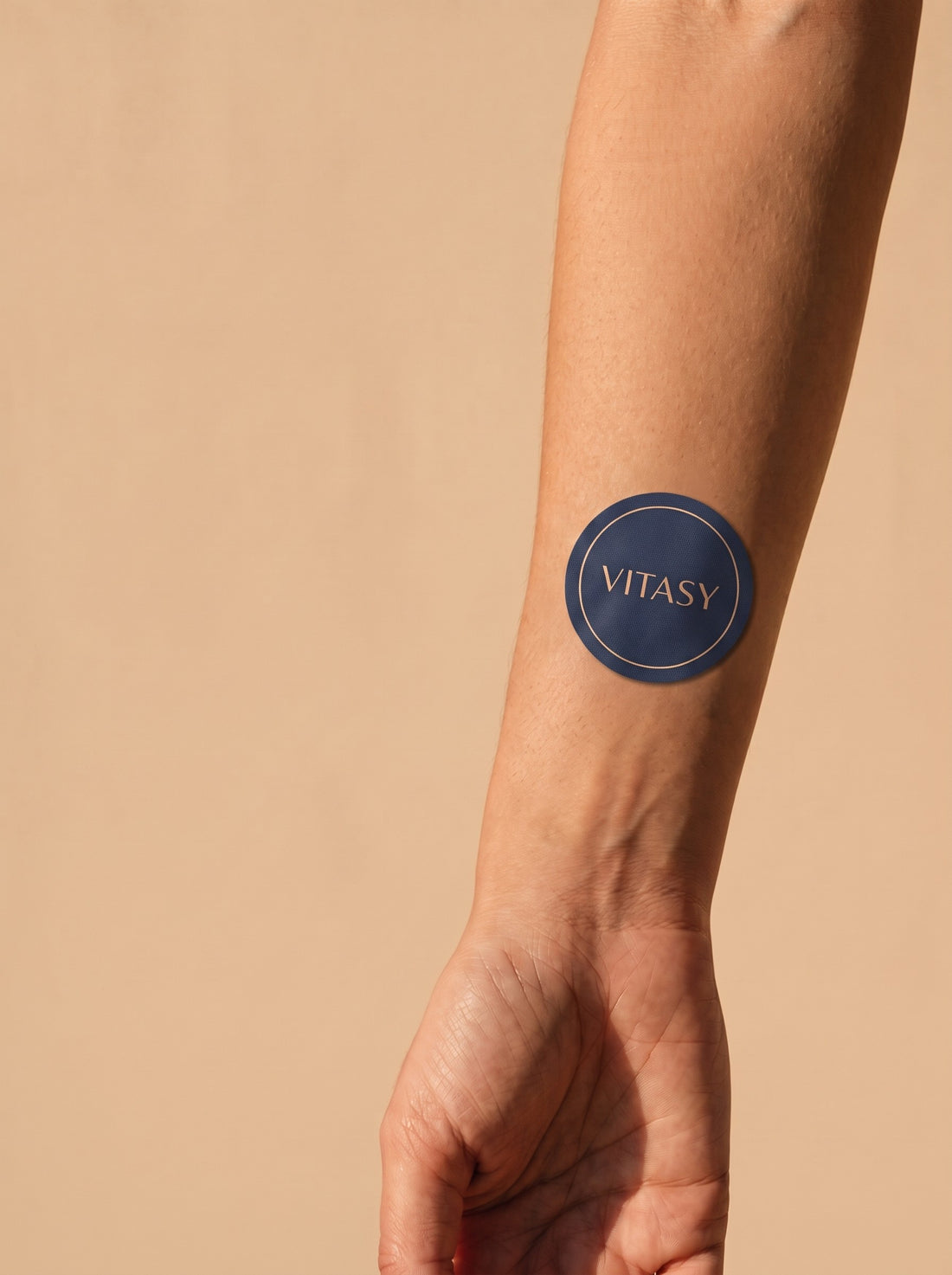 Vitasy patch on an inner forearm
