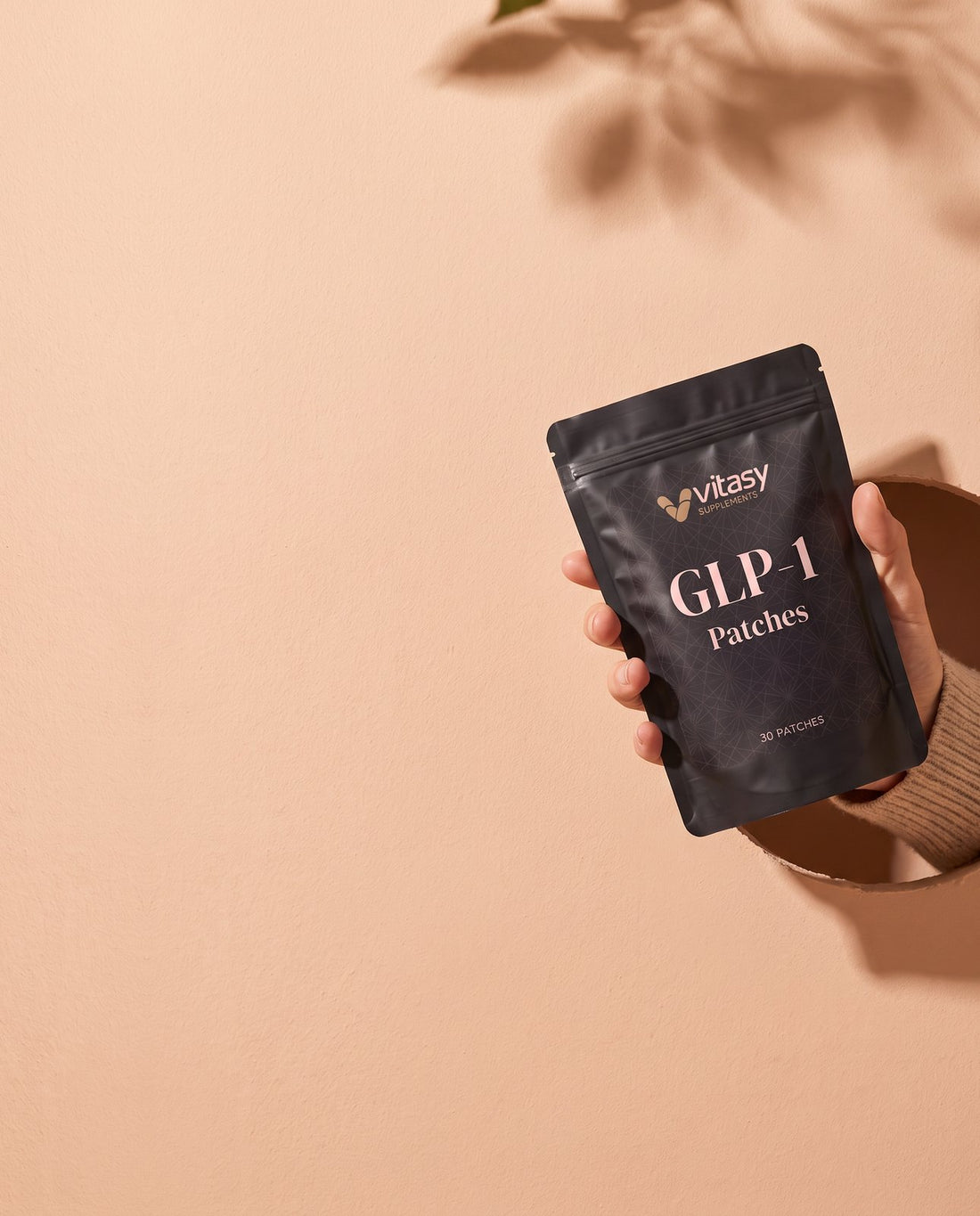 Hand holding a Vitasy patches pouch