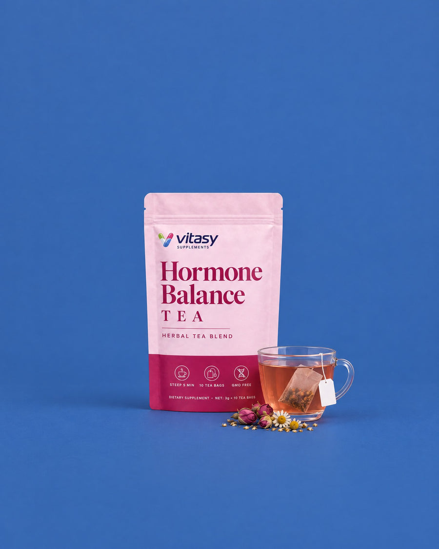 Vitasy Hormone Balance Tea pouch next to a cup of herbal tea with rosebuds and chamomile
