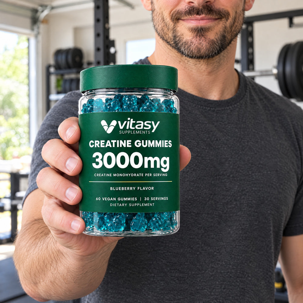 Man holding a jar of Vitasy Creatine Gummies, 3,000 mg creatine monohydrate per serving, blueberry flavor, in a home garage gym