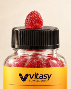 A red Vitasy saffron gummy on the bottle cap