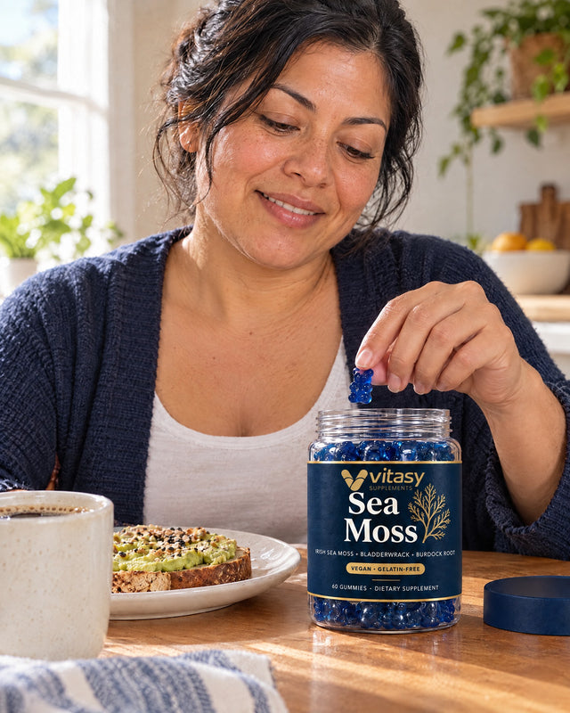 Woman taking a gummy from the Vitasy jar at breakfast