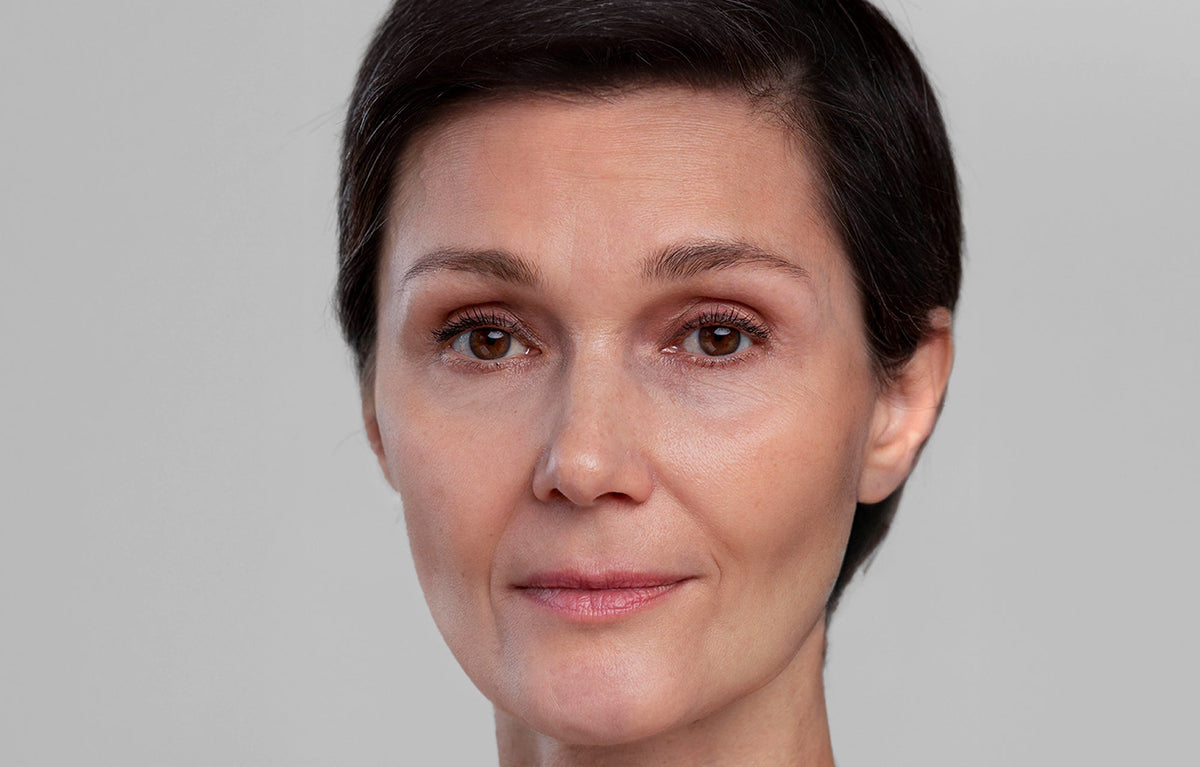 Close-up portrait of the same woman, after