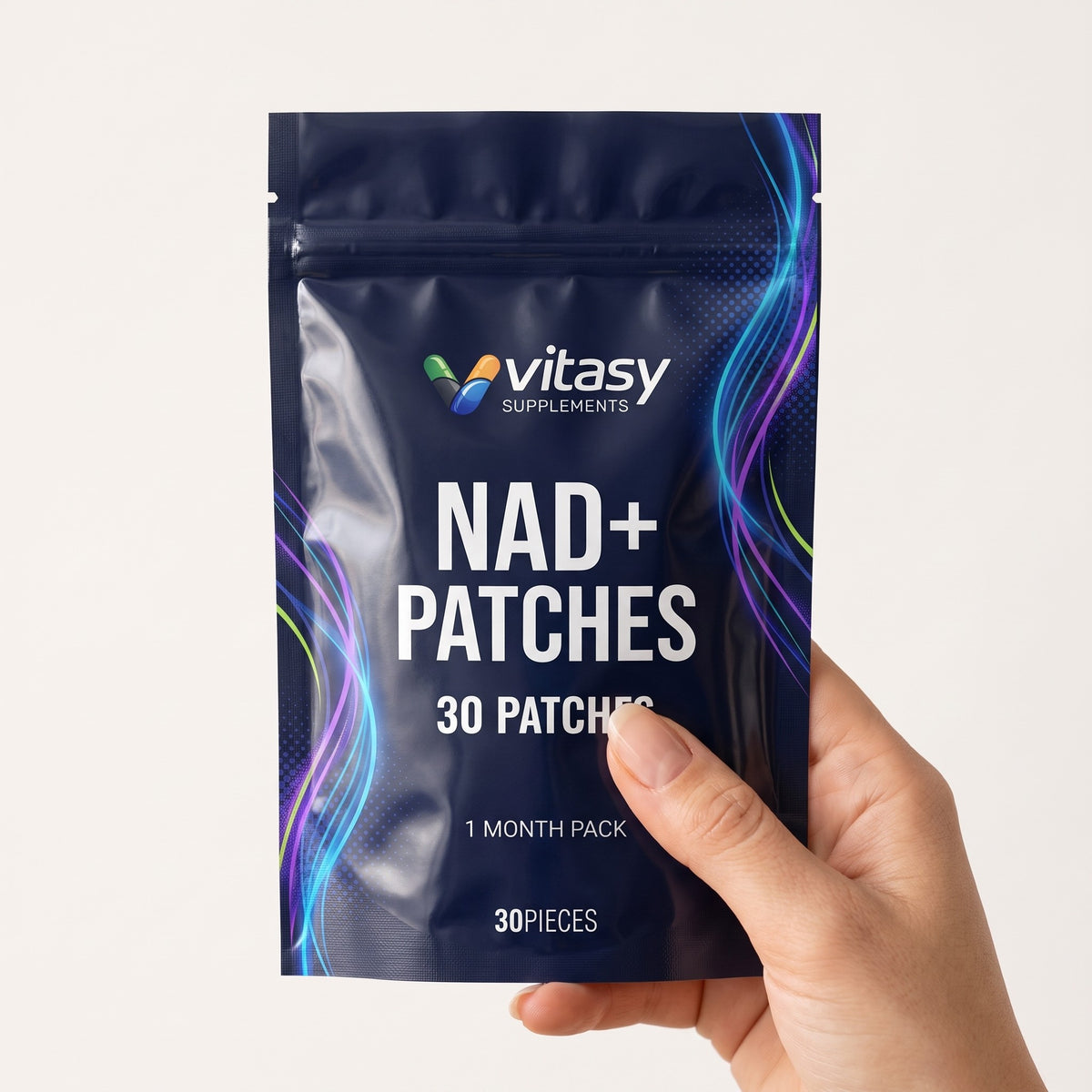 Hand holding a pouch of Vitasy NAD+ Patches