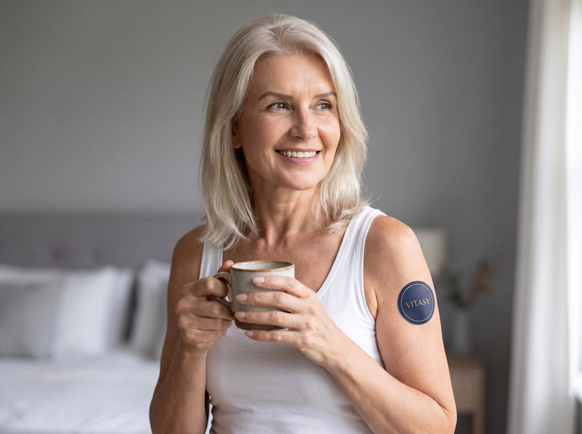 Smiling woman at home with a Vitasy patch on her upper arm