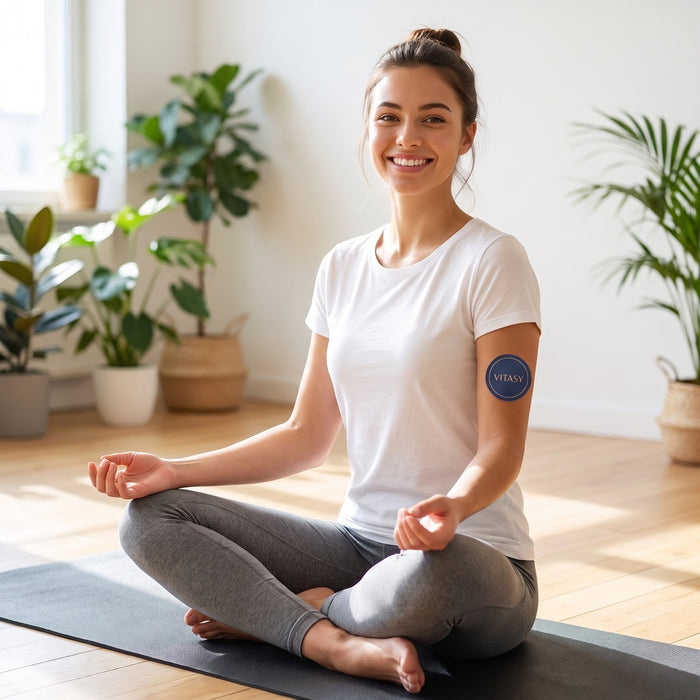 Woman on a yoga mat with a Vitasy patch on her upper arm