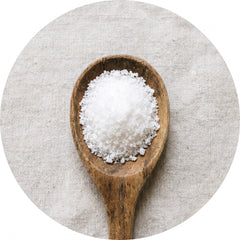 White acetyl-L-carnitine powder on a wooden spoon