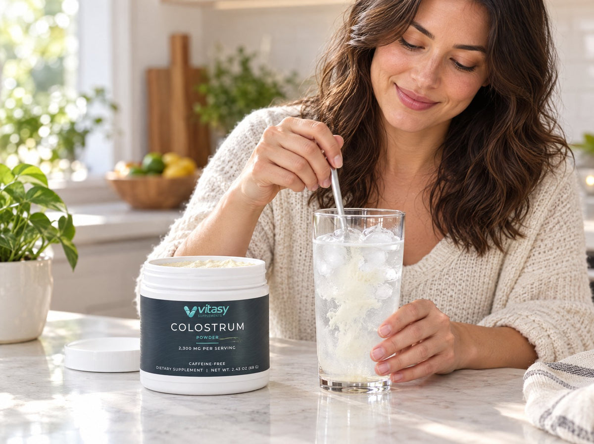 Scoop of colostrum powder stirred into a glass of cold water