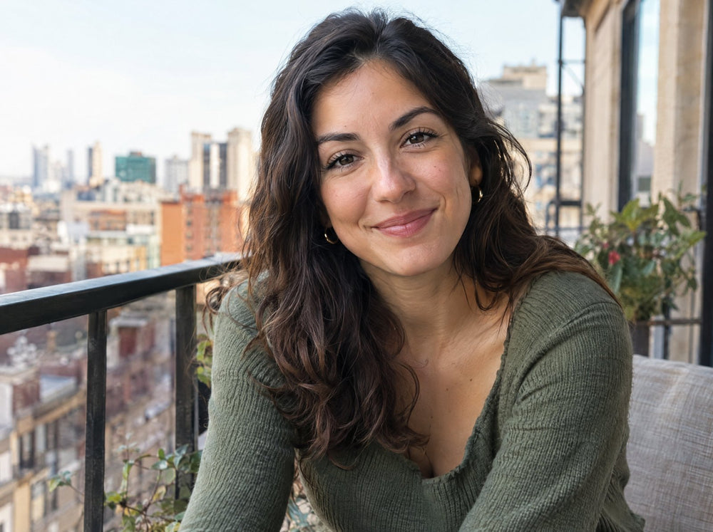Woman in her late twenties on a city balcony