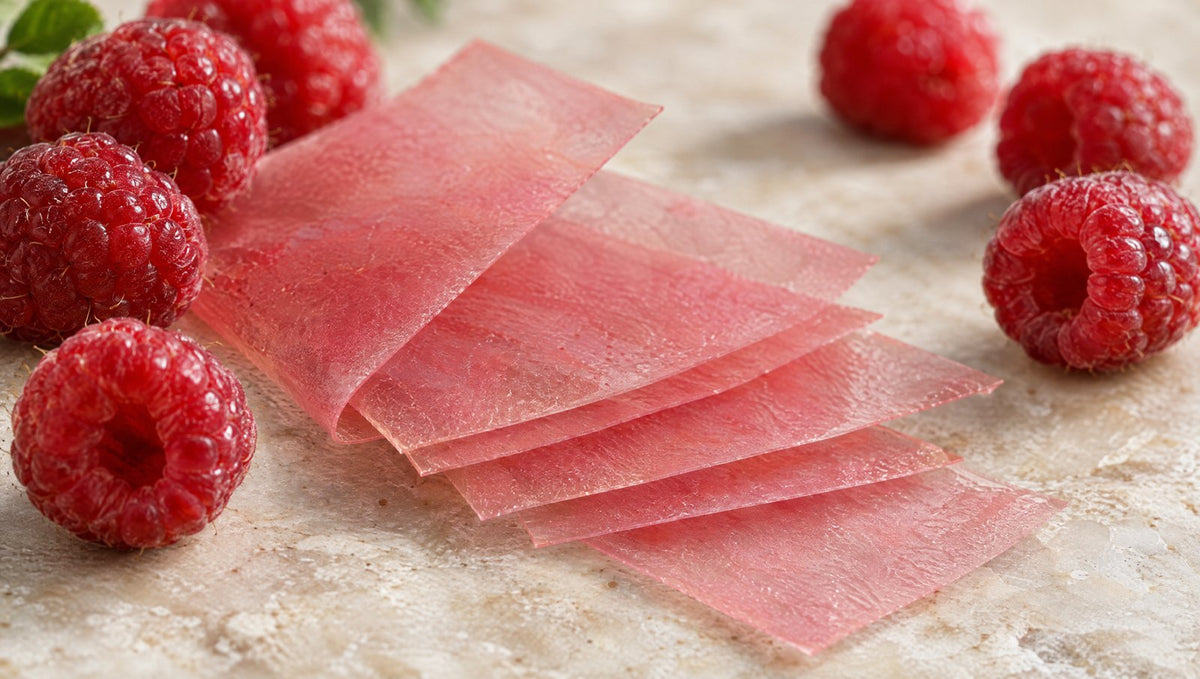 Close-up of pink oral strips and raspberries