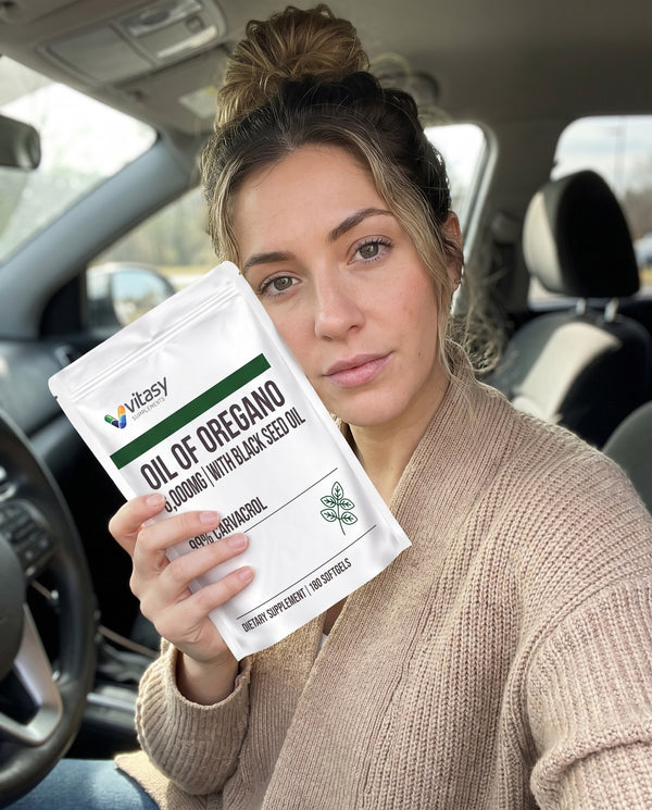 Woman holding Vitasy Oil of Oregano in her car