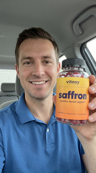 Man holding Vitasy Saffron Gummies in his car