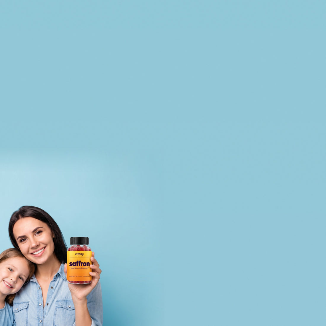 Mother and daughter with Vitasy Saffron Gummies next to the Supplement Facts panel