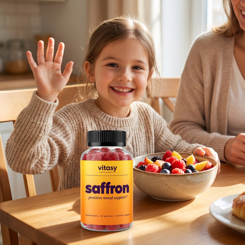 Smiling girl at the breakfast table next to a bottle of Vitasy Saffron Gummies