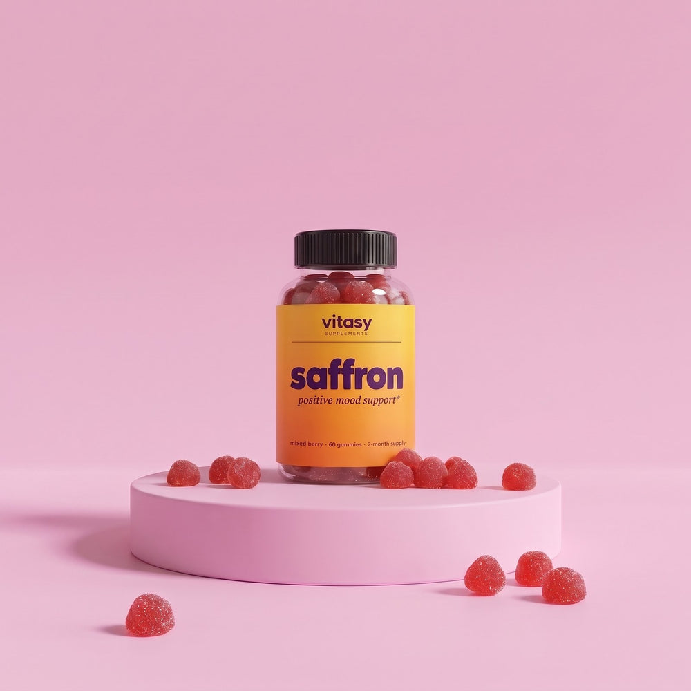 Vitasy Saffron Gummies jar on a pink podium