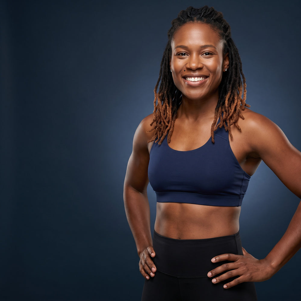 Smiling woman in navy activewear in a studio