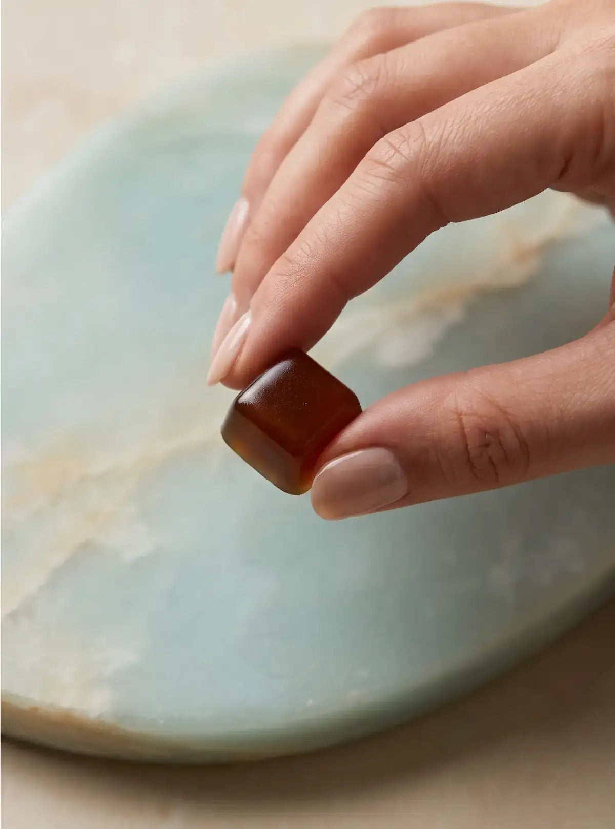 Hand holding a gummy