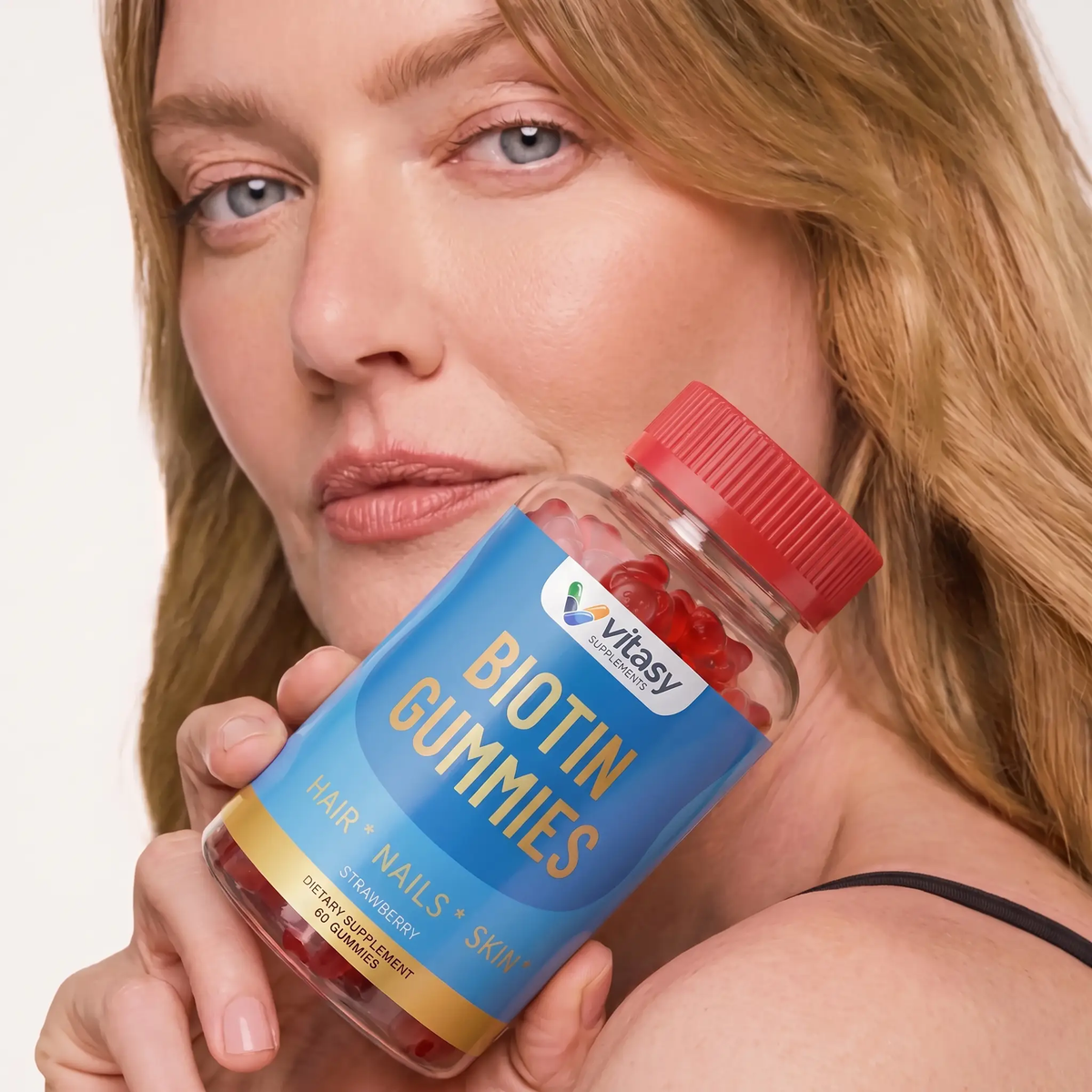 Biotin Gummies v4 - Gallery Image 5 - woman holding Strawberry bottle