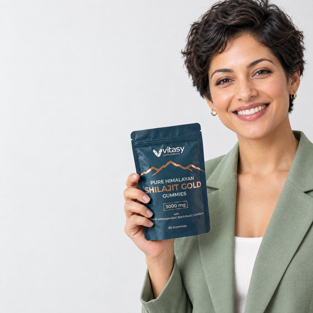 Smiling woman holding a pouch of Vitasy Shilajit Gummies