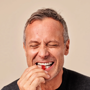 Biotin Gummies v4 - Gallery Image 7 - man eating one Strawberry bear gummy