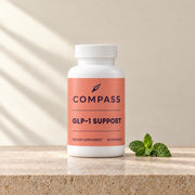 Compass GLP-1 Support coral, 60 capsules, bottle on travertine
