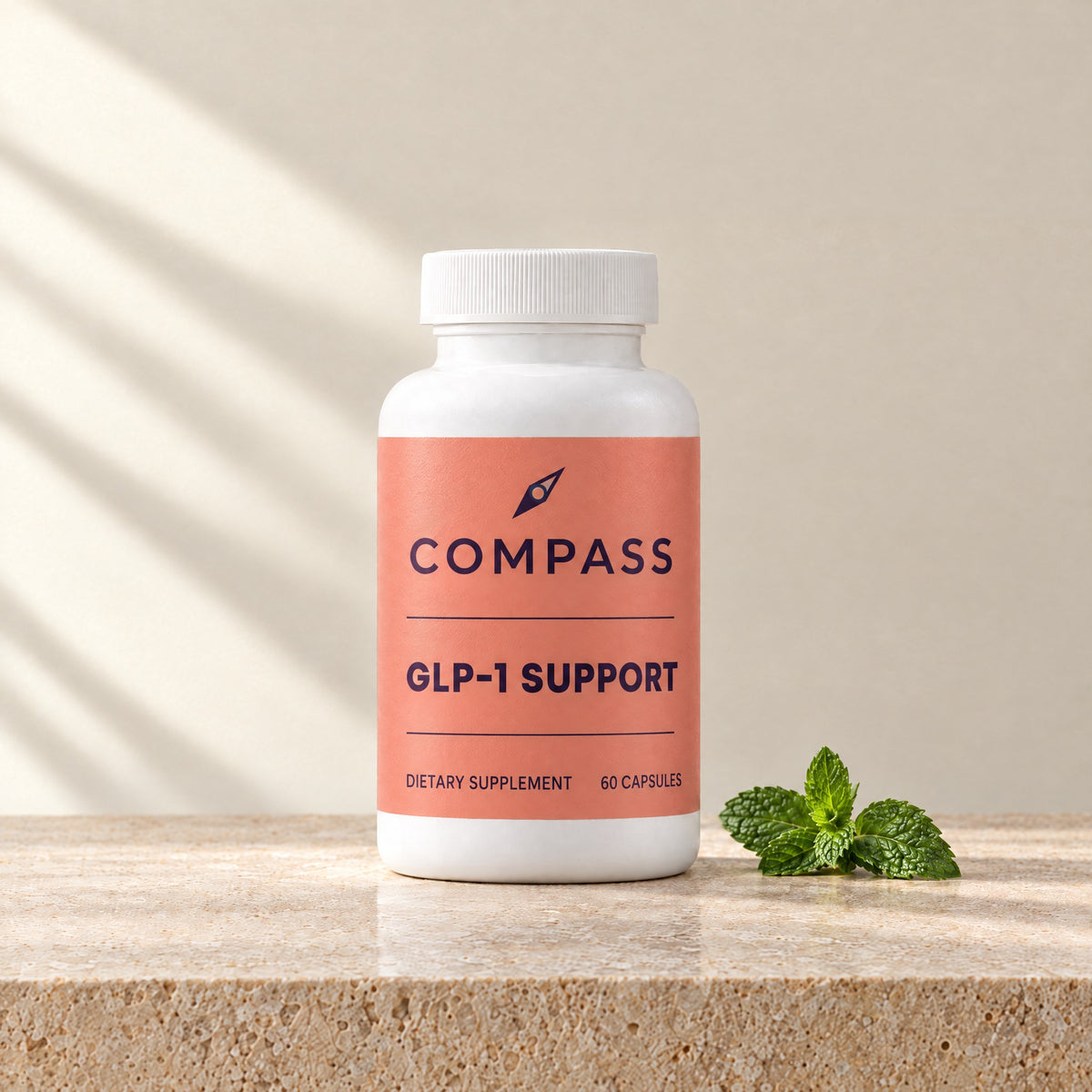 Compass GLP-1 Support coral, 60 capsules, bottle on travertine