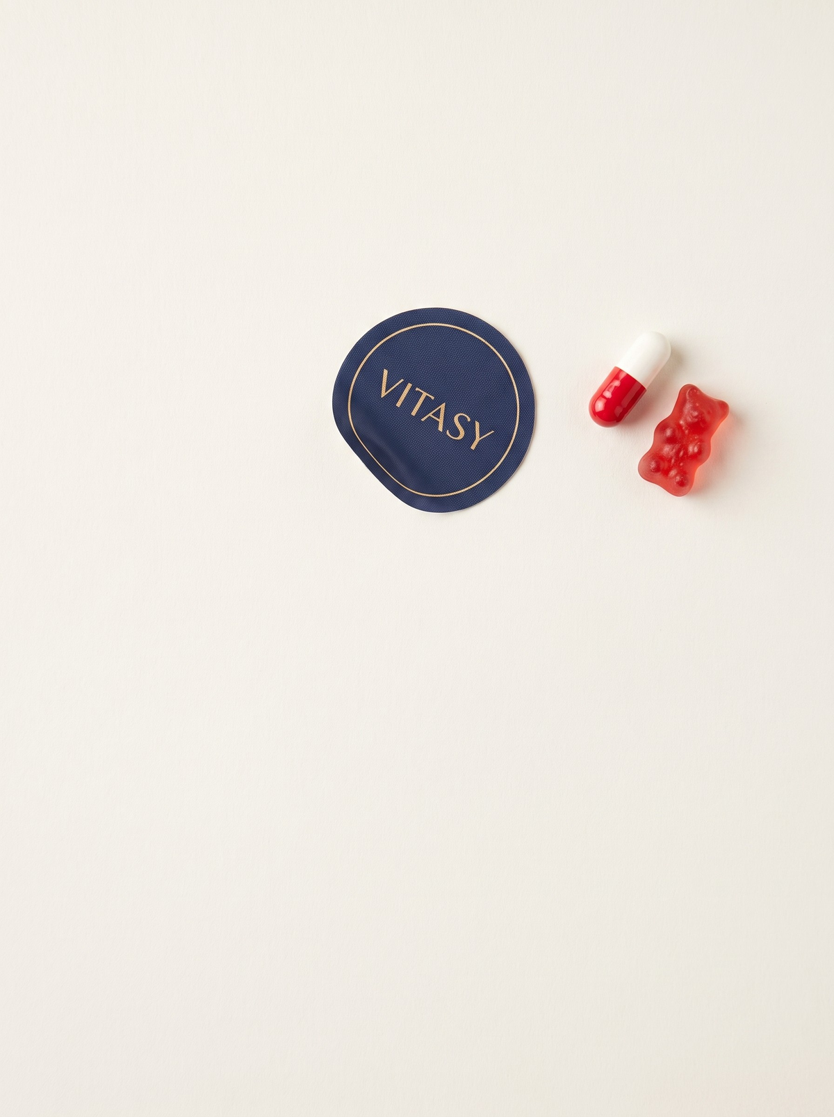 Vitasy patch next to a capsule and a gummy