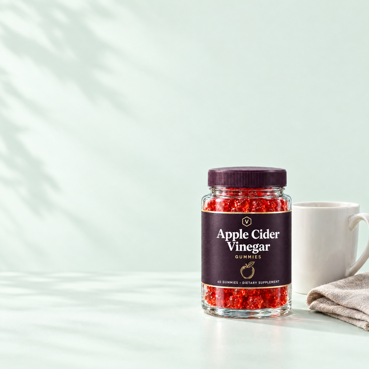 Vitasy Apple Cider Vinegar Gummies jar next to a mug