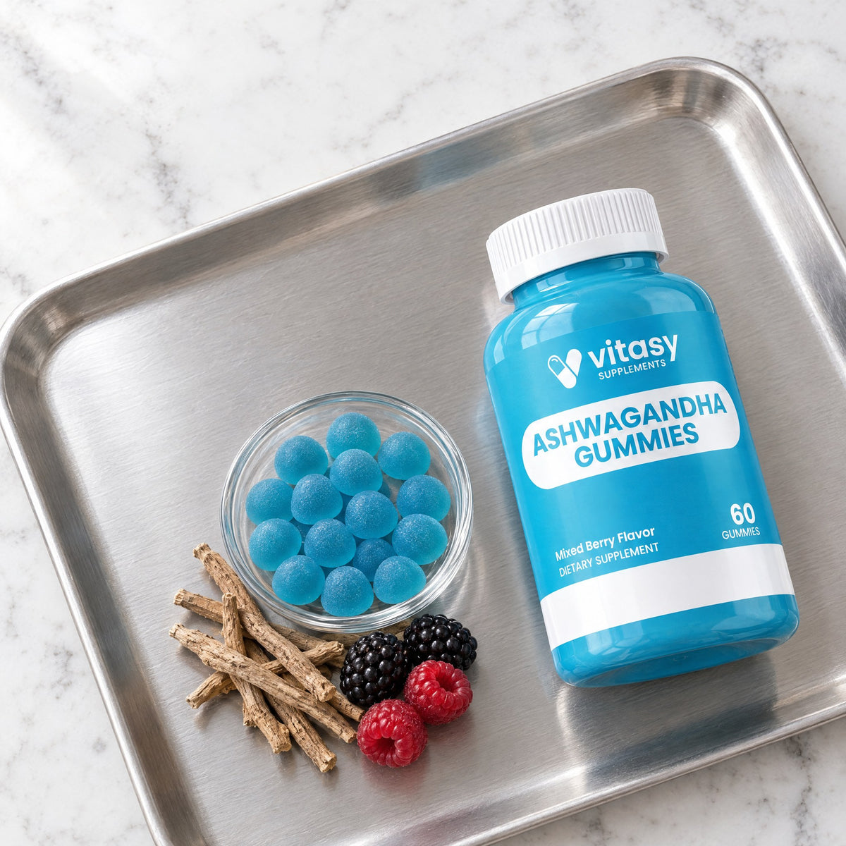Bottle of Vitasy Ashwagandha Gummies on a tray with blue gummies and berries