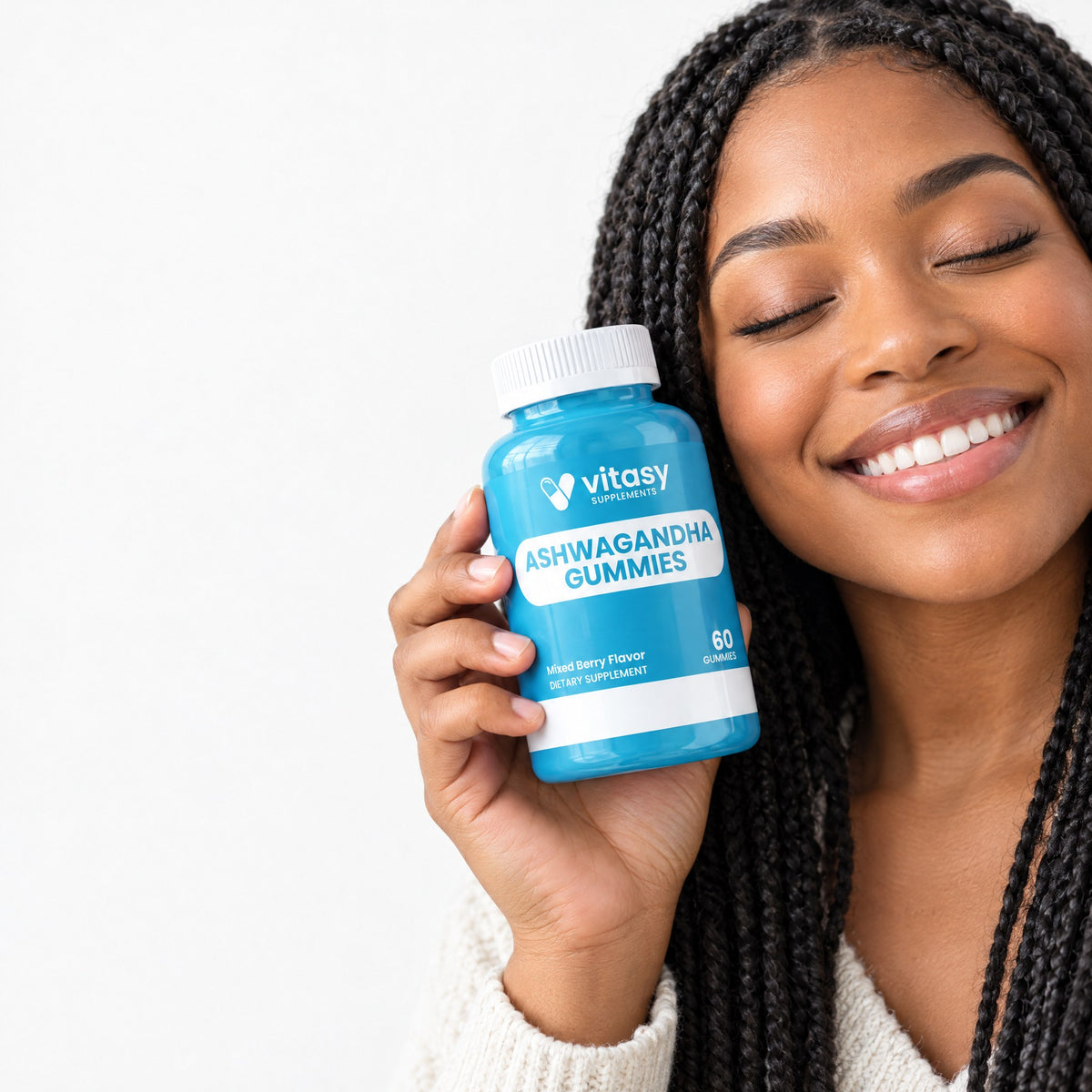 Smiling woman holding a bottle of Vitasy Ashwagandha Gummies