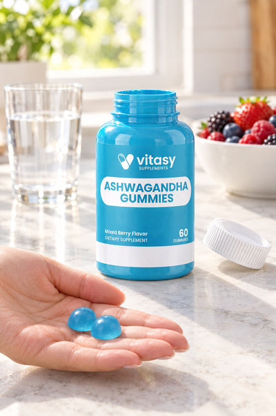 Two blue gummies in a hand next to the bottle