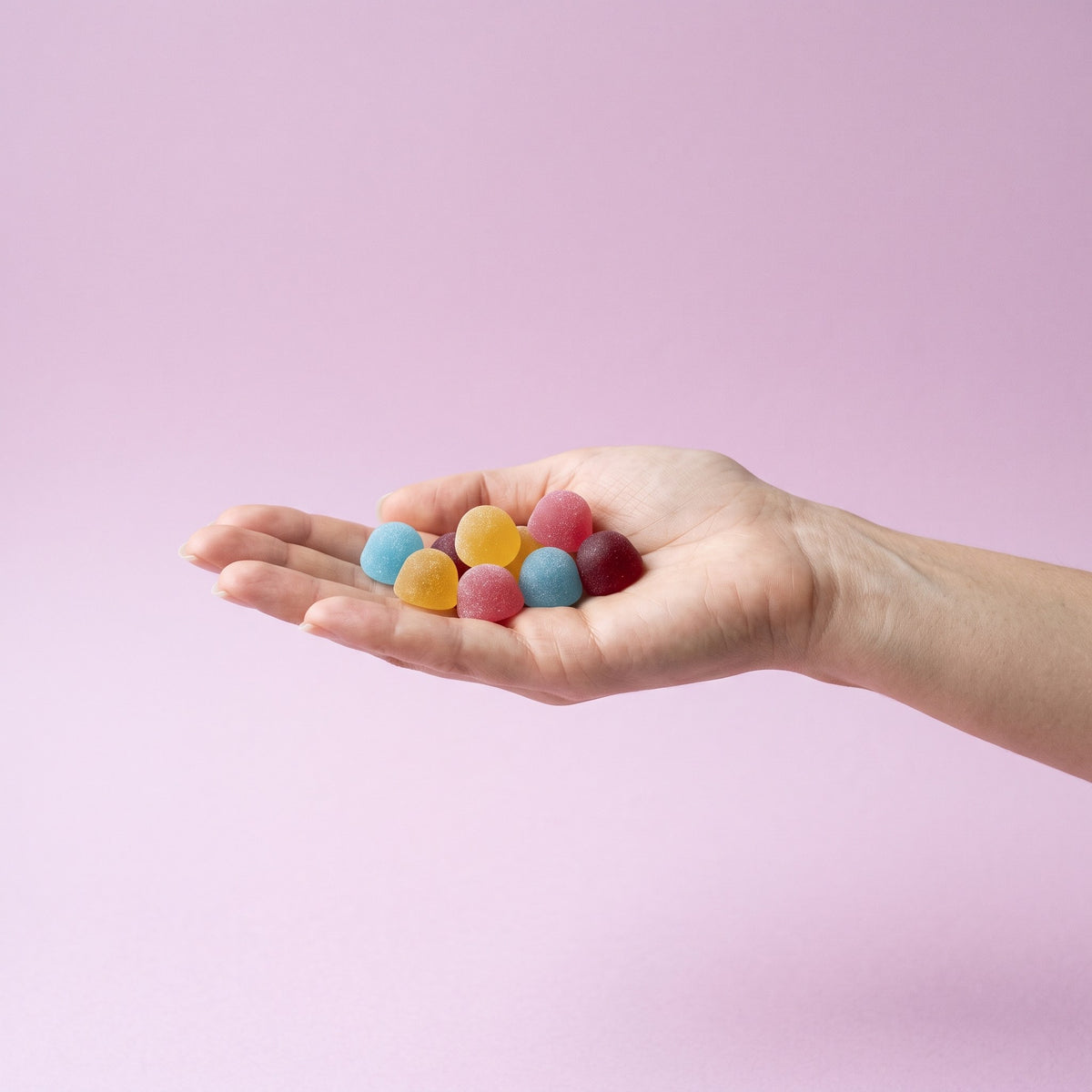 Hand holding colorful ashwagandha gummies