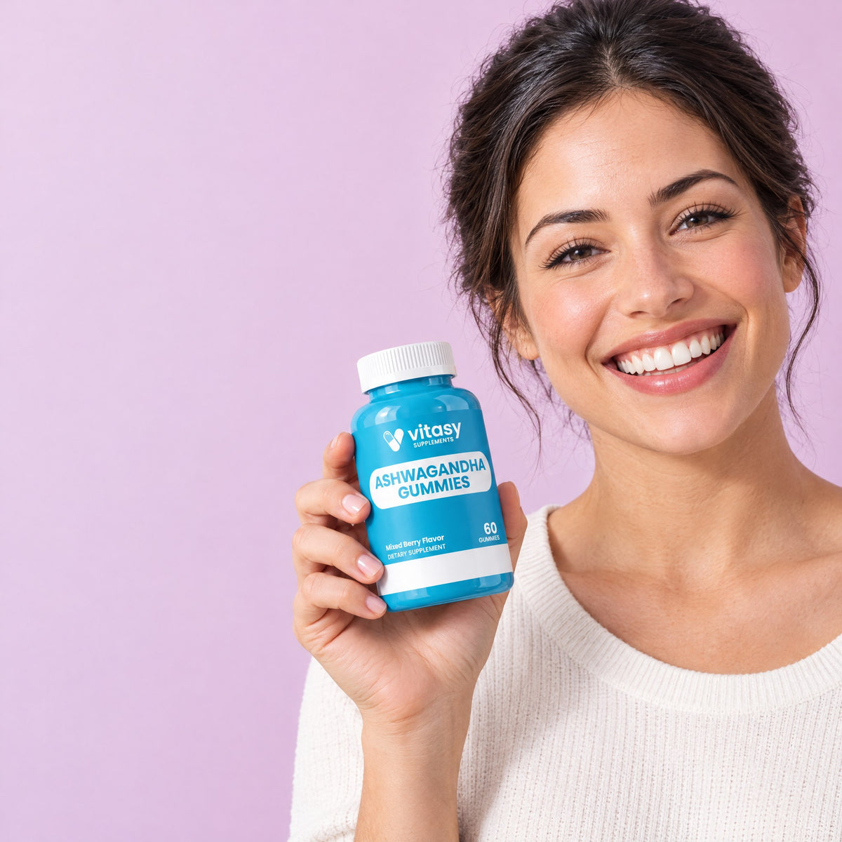 Smiling woman holding Vitasy Ashwagandha Gummies