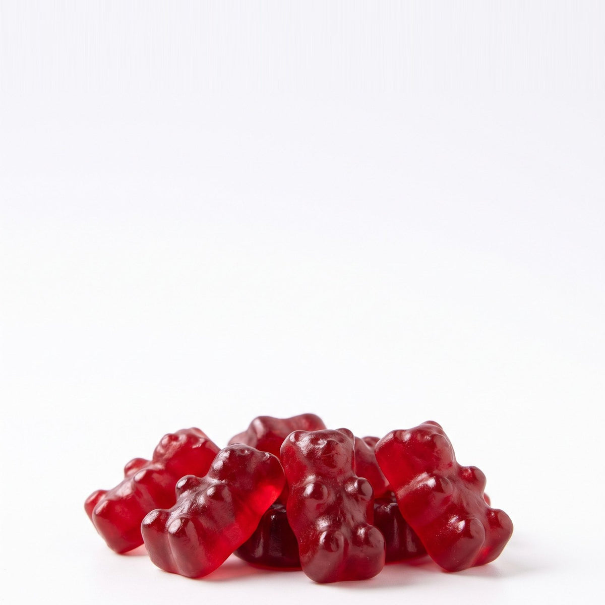 Red apple cider vinegar gummy bears on white
