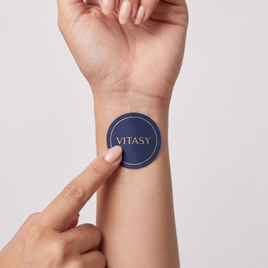 Pressing a Vitasy patch onto the wrist