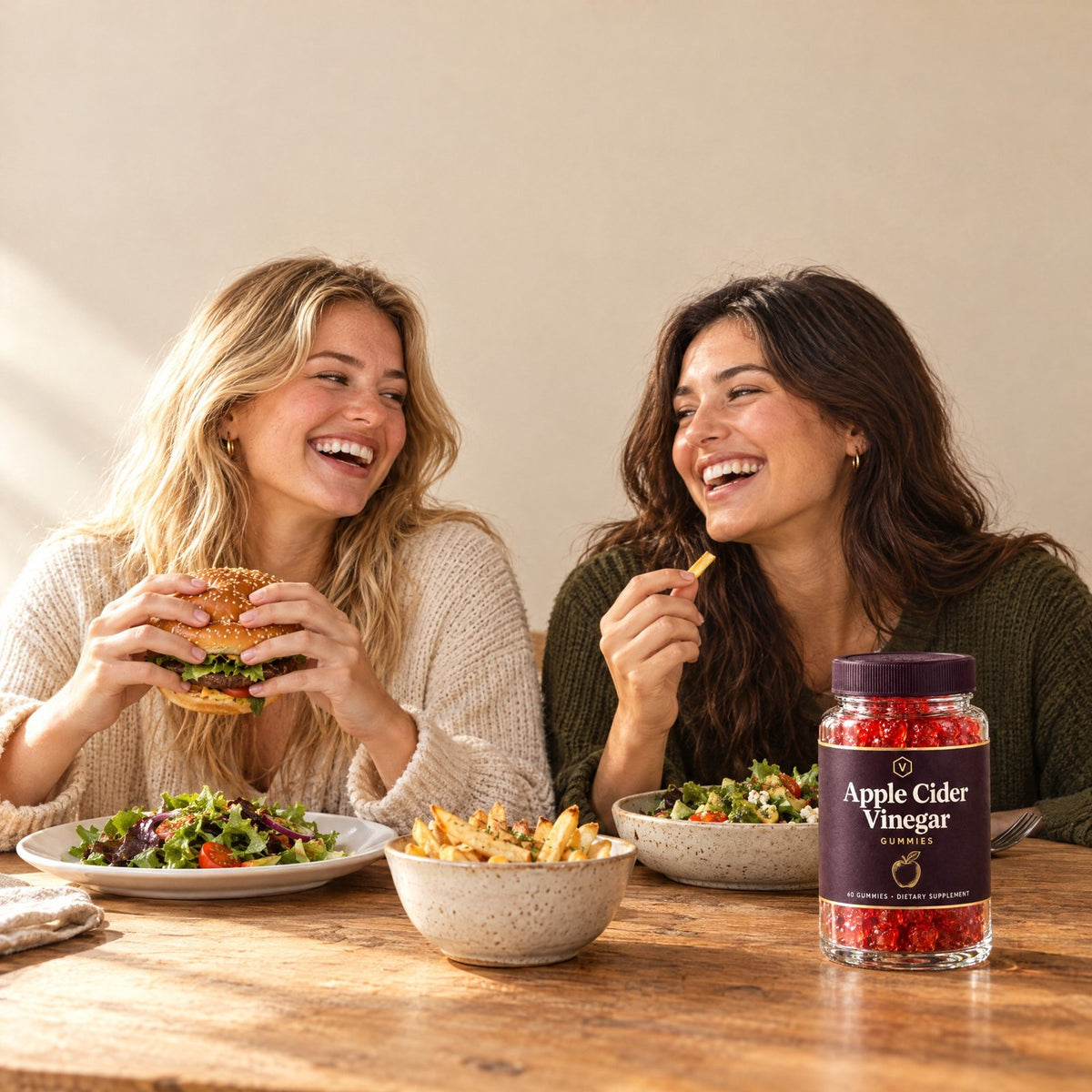 Two friends at a table with a jar of Vitasy Apple Cider Vinegar Gummies
