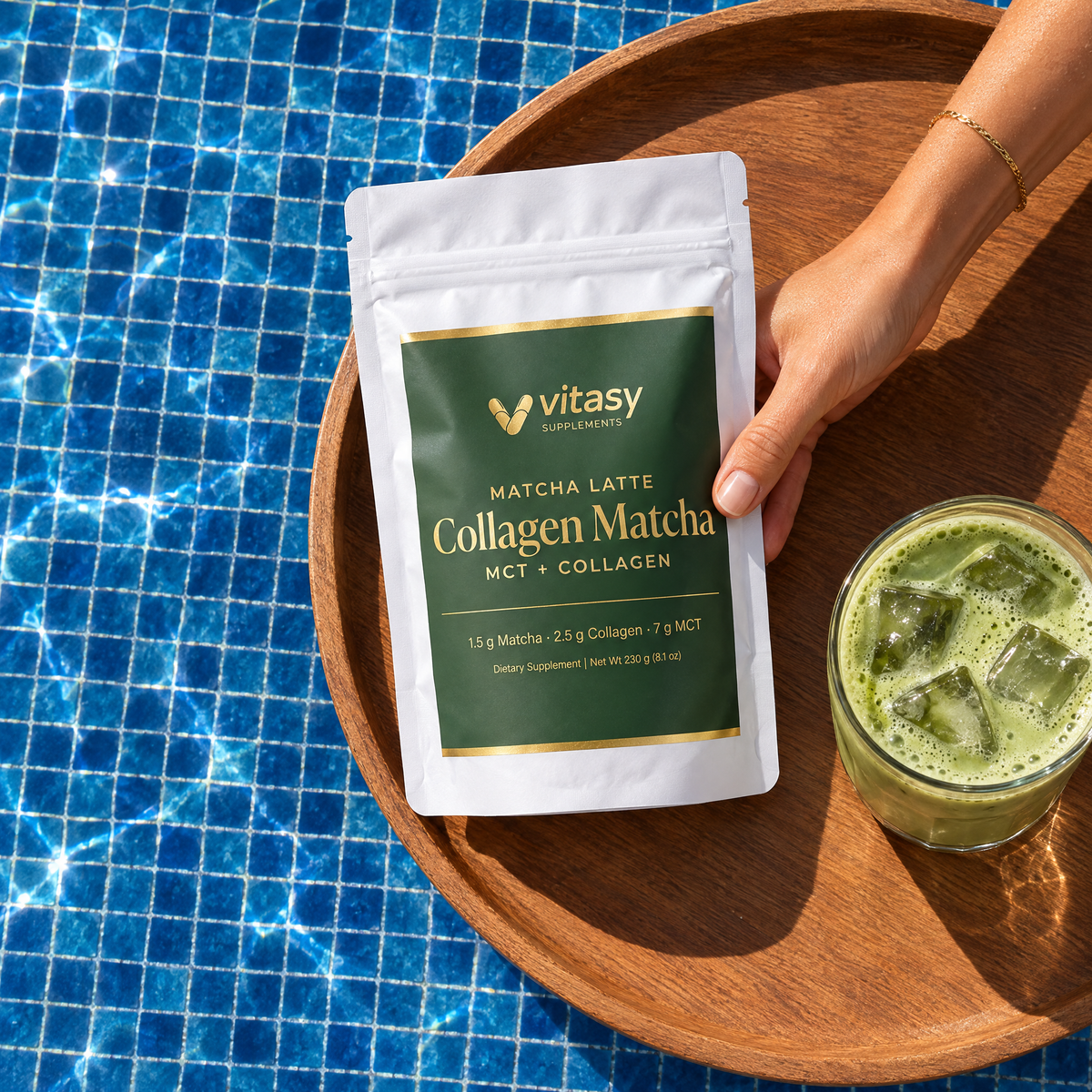 Hand holding the Vitasy Collagen Matcha pouch next to an iced matcha latte