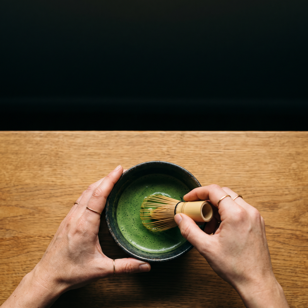 Whisking a matcha latte in a bowl