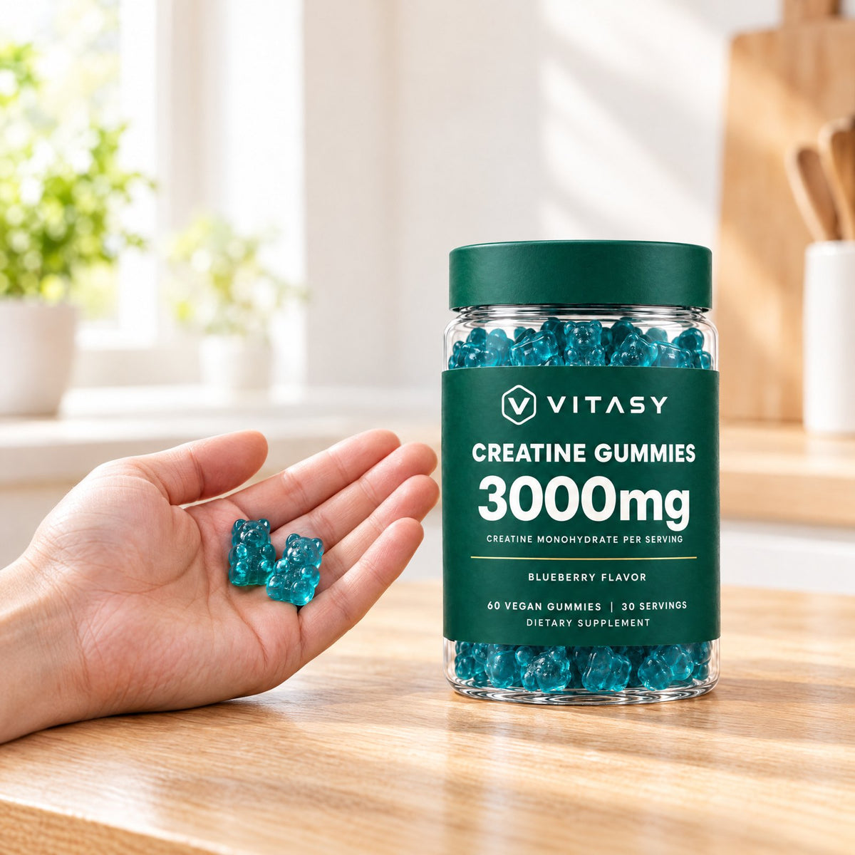 Two creatine gummies in a hand next to a jar of Vitasy Creatine Gummies