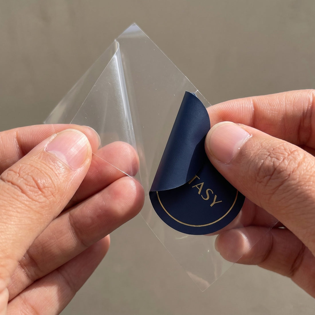 Hands peeling an Energy Patch from its backing sheet